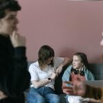 Young professionals engaging in a relaxed and collaborative office meeting with a warm and inviting atmosphere.