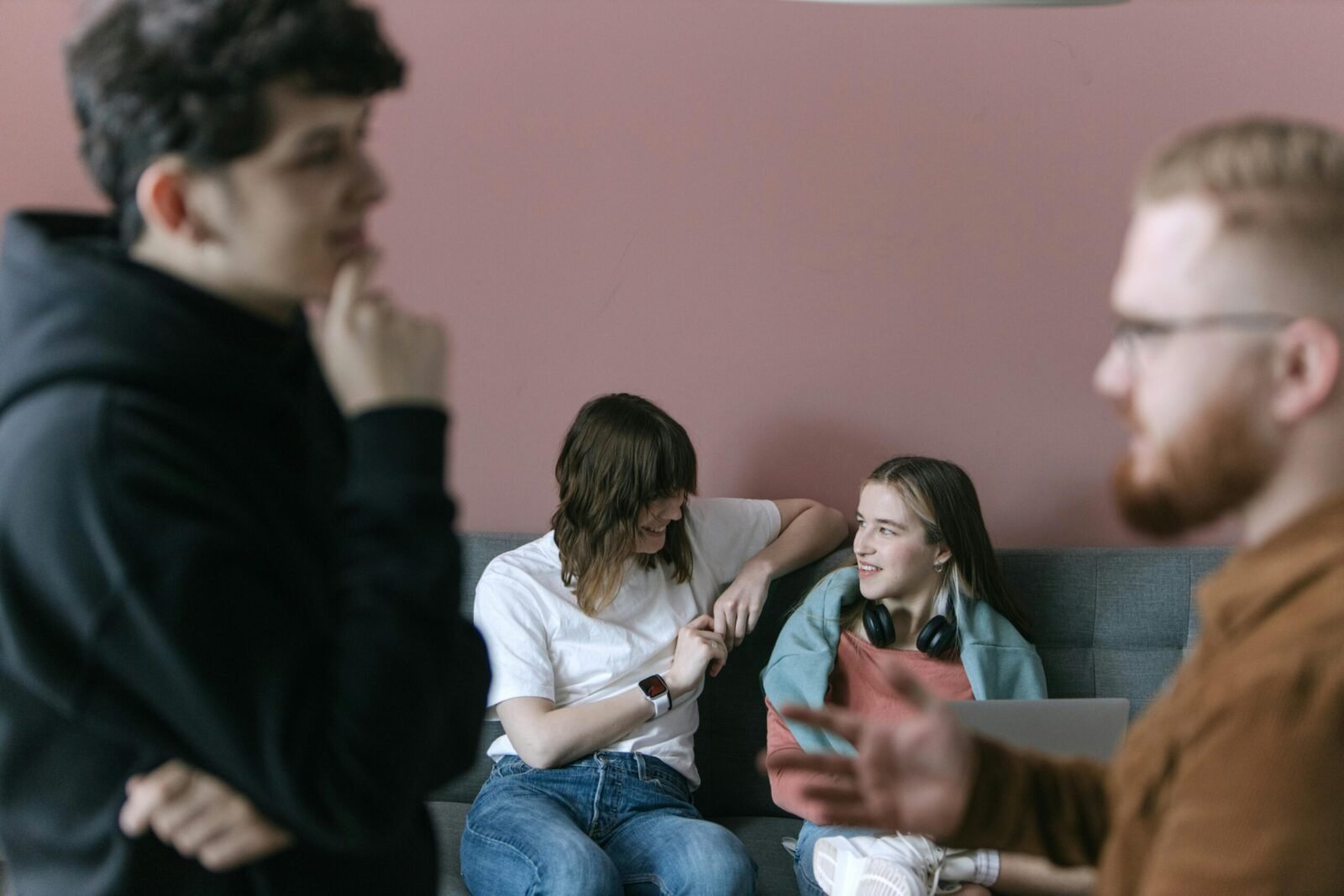 Young professionals engaging in a relaxed and collaborative office meeting with a warm and inviting atmosphere.