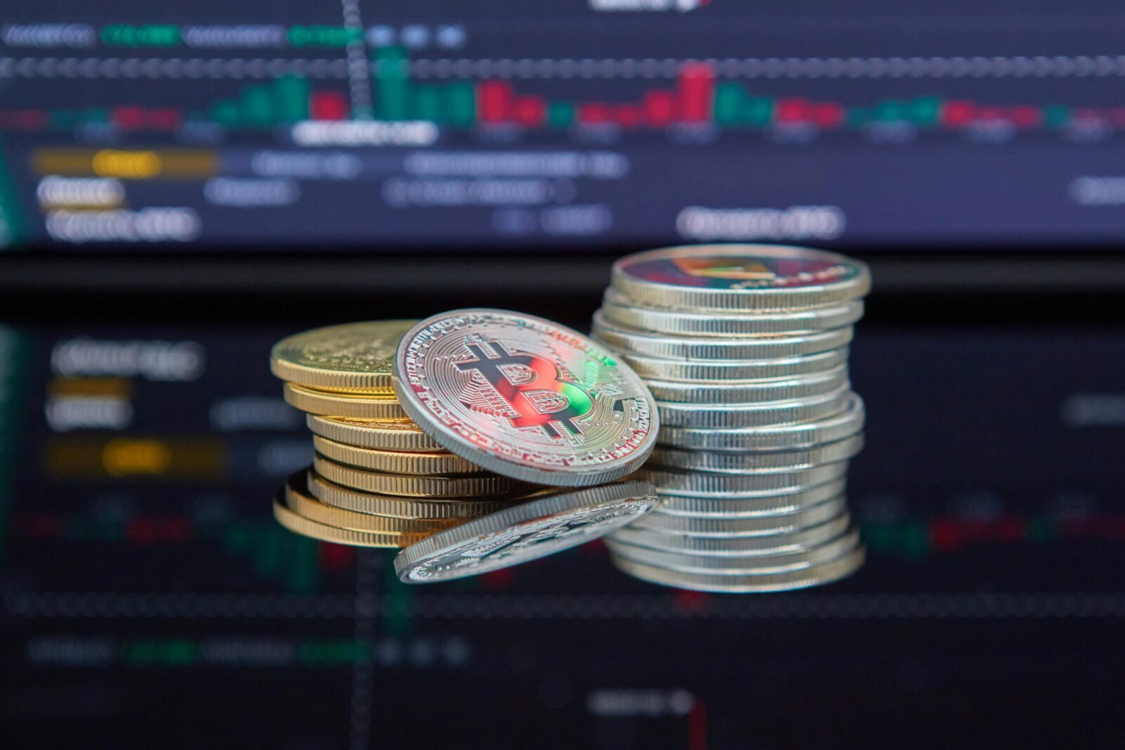 Close-up of cryptocurrency coins with a market graph background.